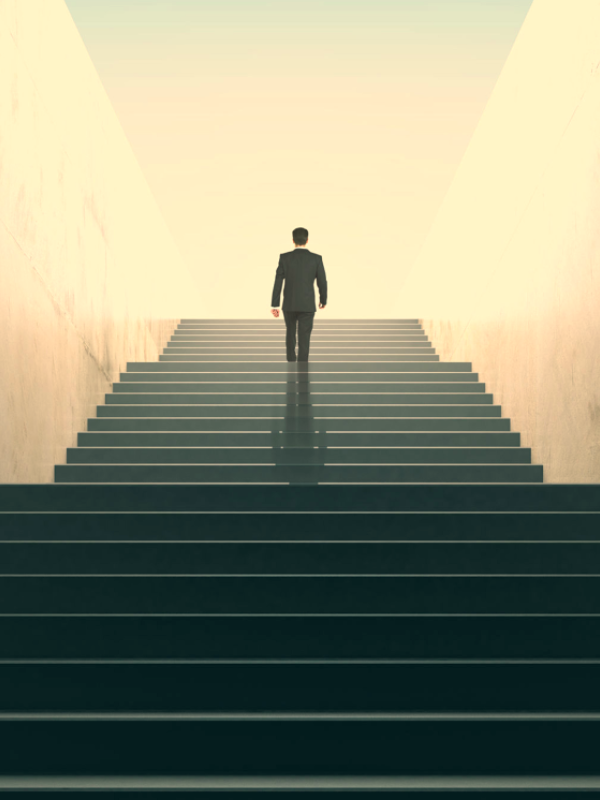 A person climbing stairs, symbolizing progress and achieving financial goals with EarnifyNow.